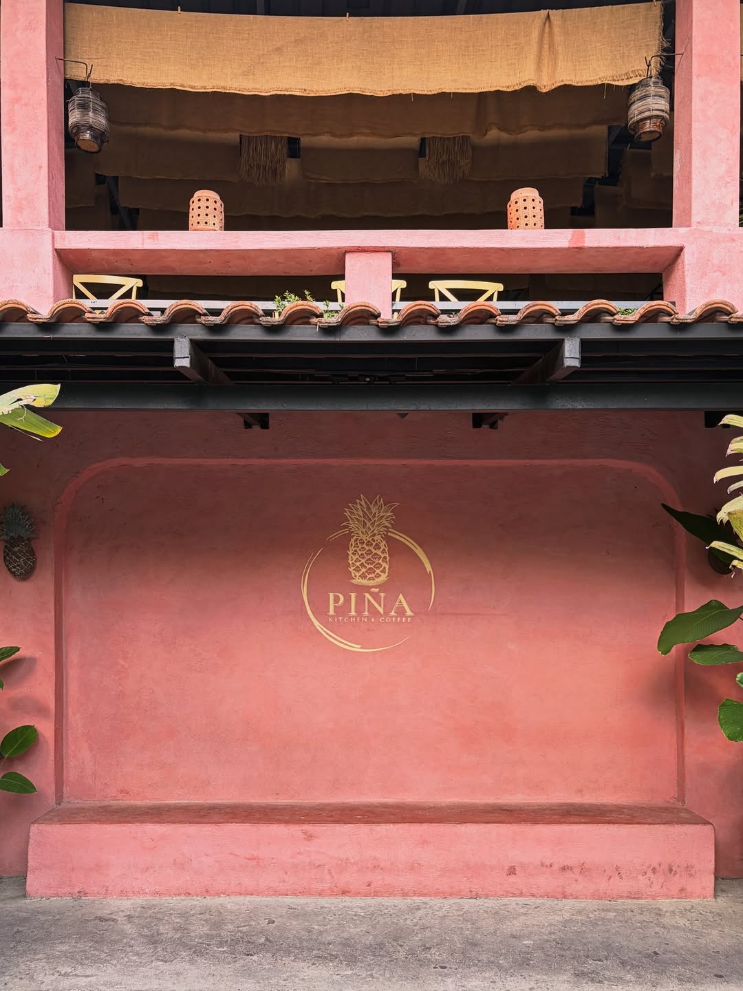 PIÑA facade — terracotta wall with gold pineapple logo